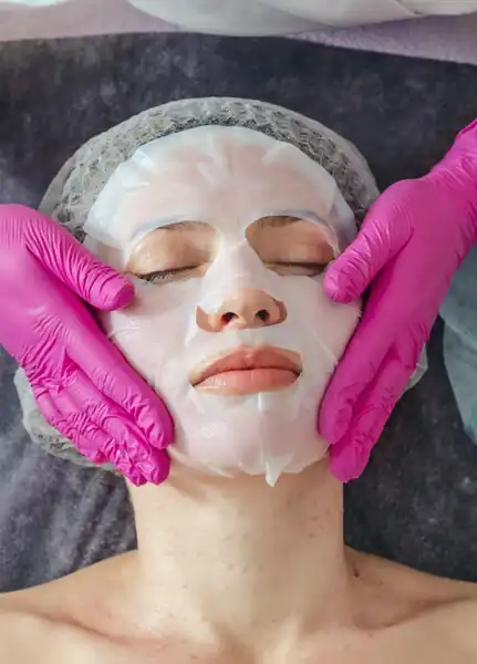 Woman receiving facial with mask on