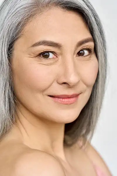 Mature woman with gray hair smiling